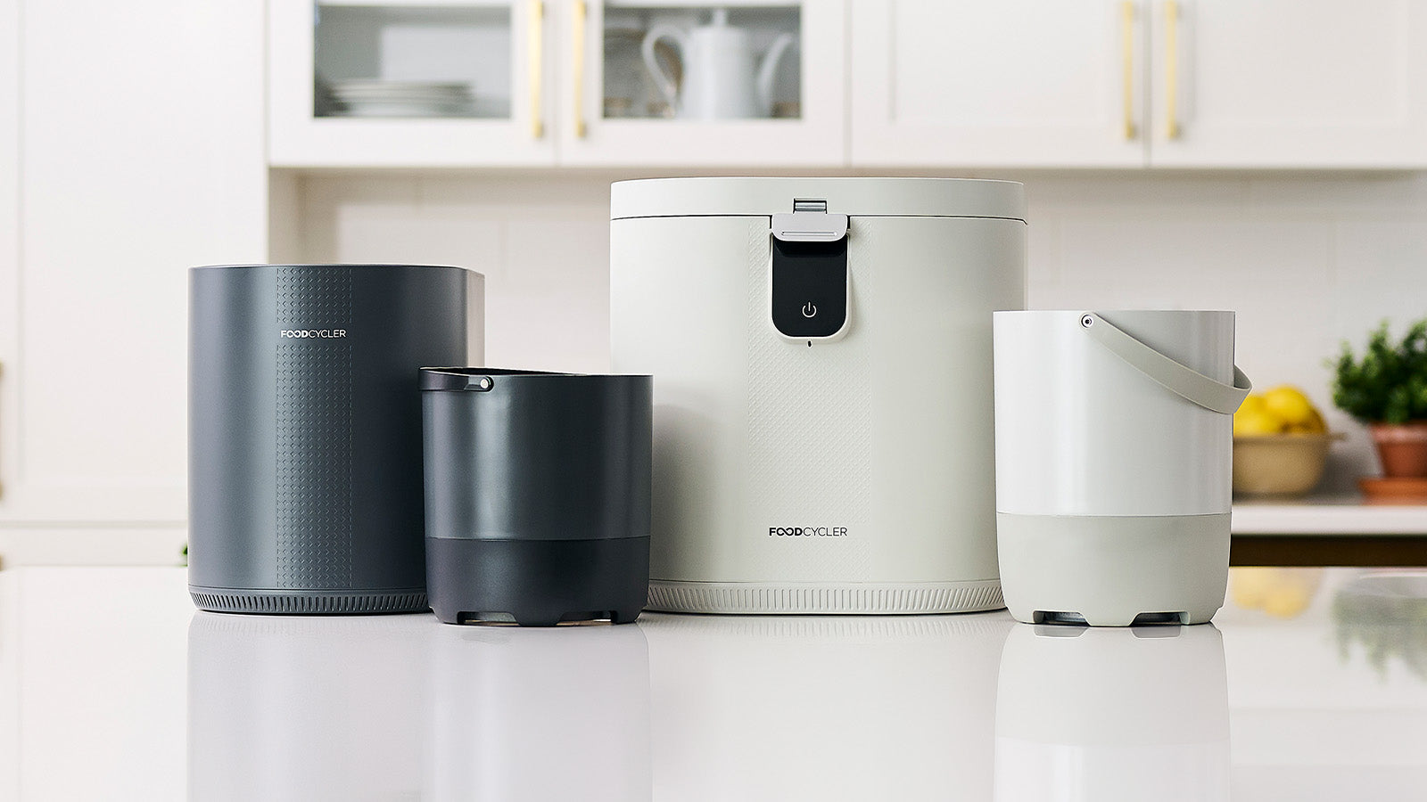 Full FoodCycler product lineup including Eco 3, Eco 5, and buckets on a kitchen counter