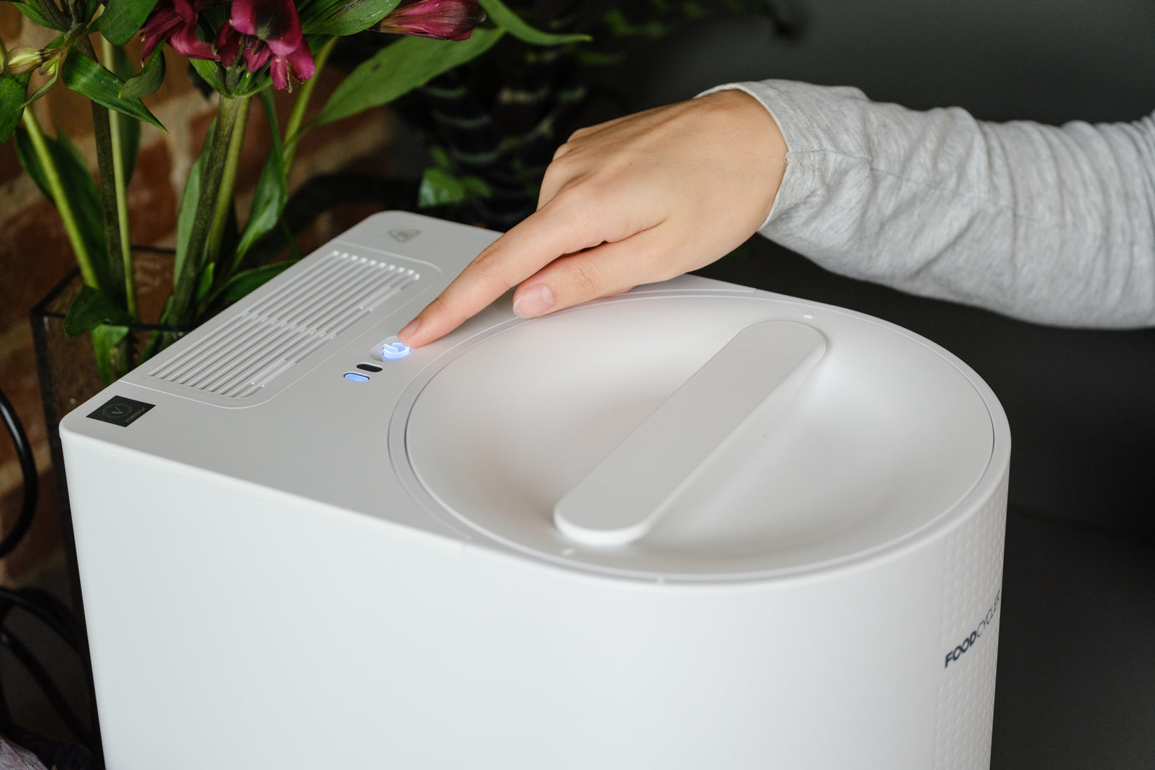 Person turning on their White FoodCycler Eco 3 to run a cycle