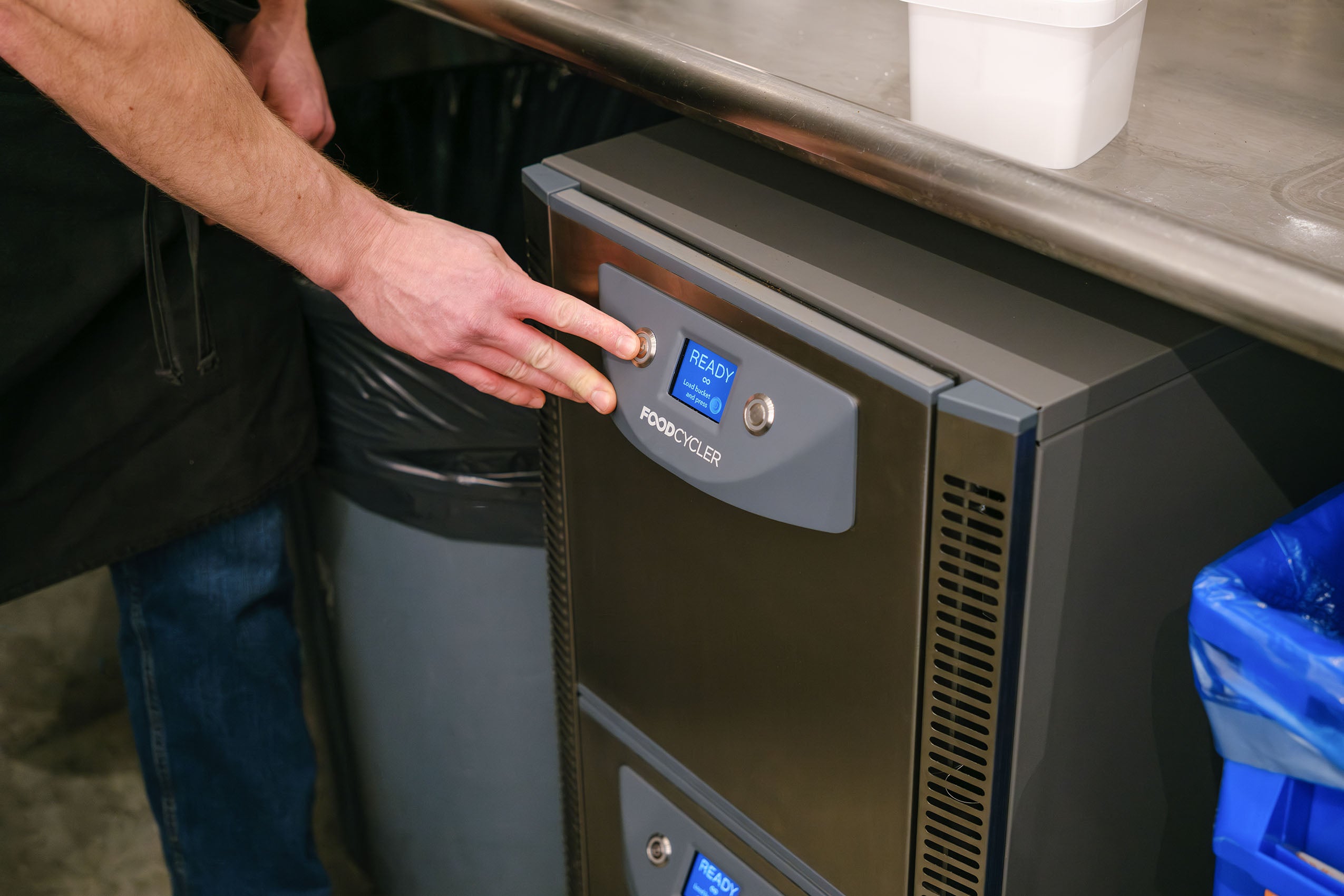 Person powering on the FoodCycler FC-75